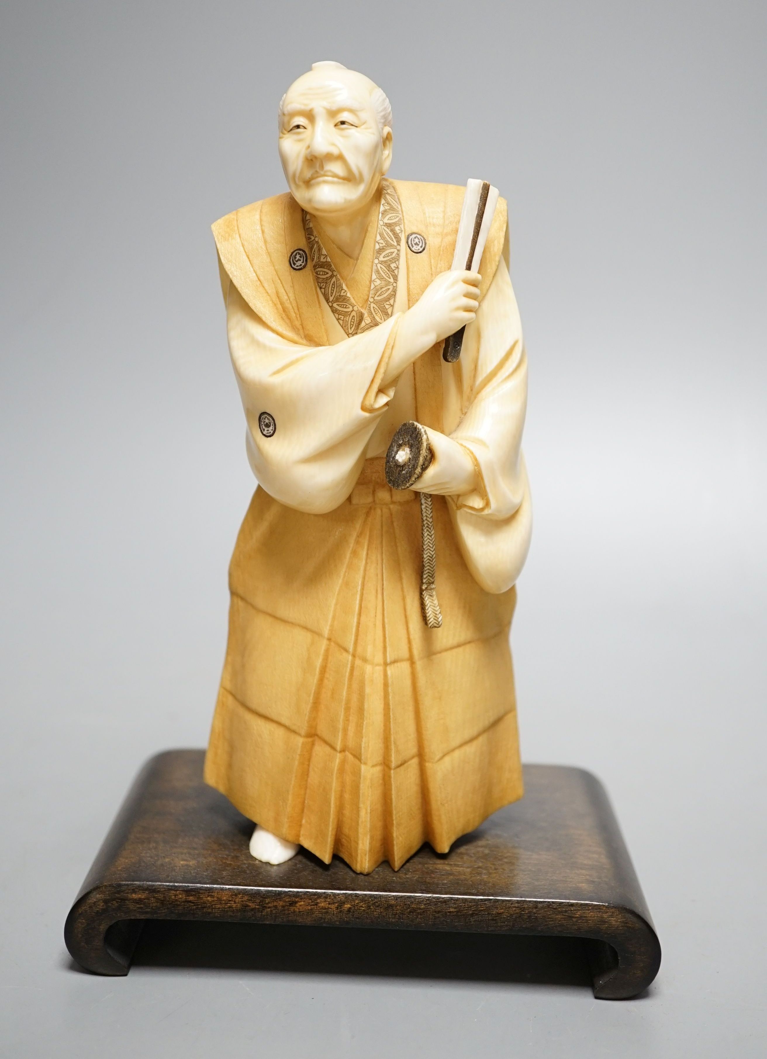 A Japanese ivory figure of a Samurai general, Taisho/early Showa period, signed to a lacquer tablet - 19cm tall